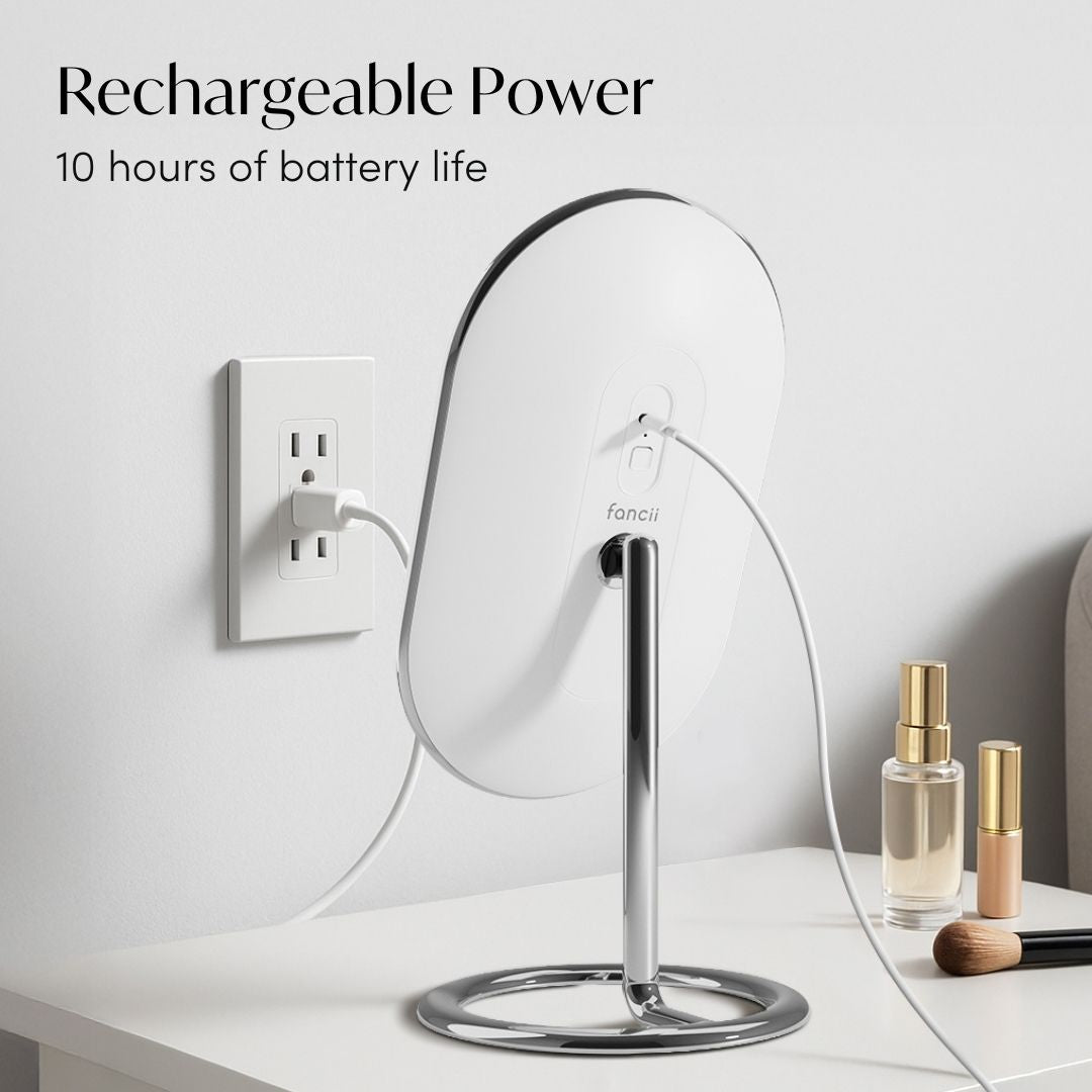 Vera LED vanity makeup mirror charging with USB cable, 10-hour rechargeable battery, on a white desk.