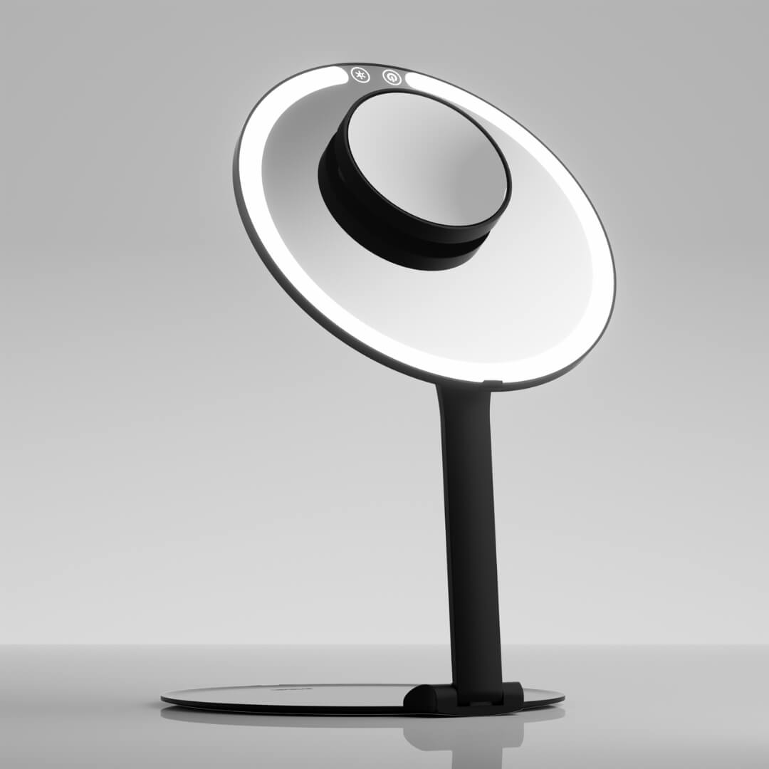 Tara 10x Magnifying Suction Mirror attached to the face of a black LED lighted makeup vanity mirror.