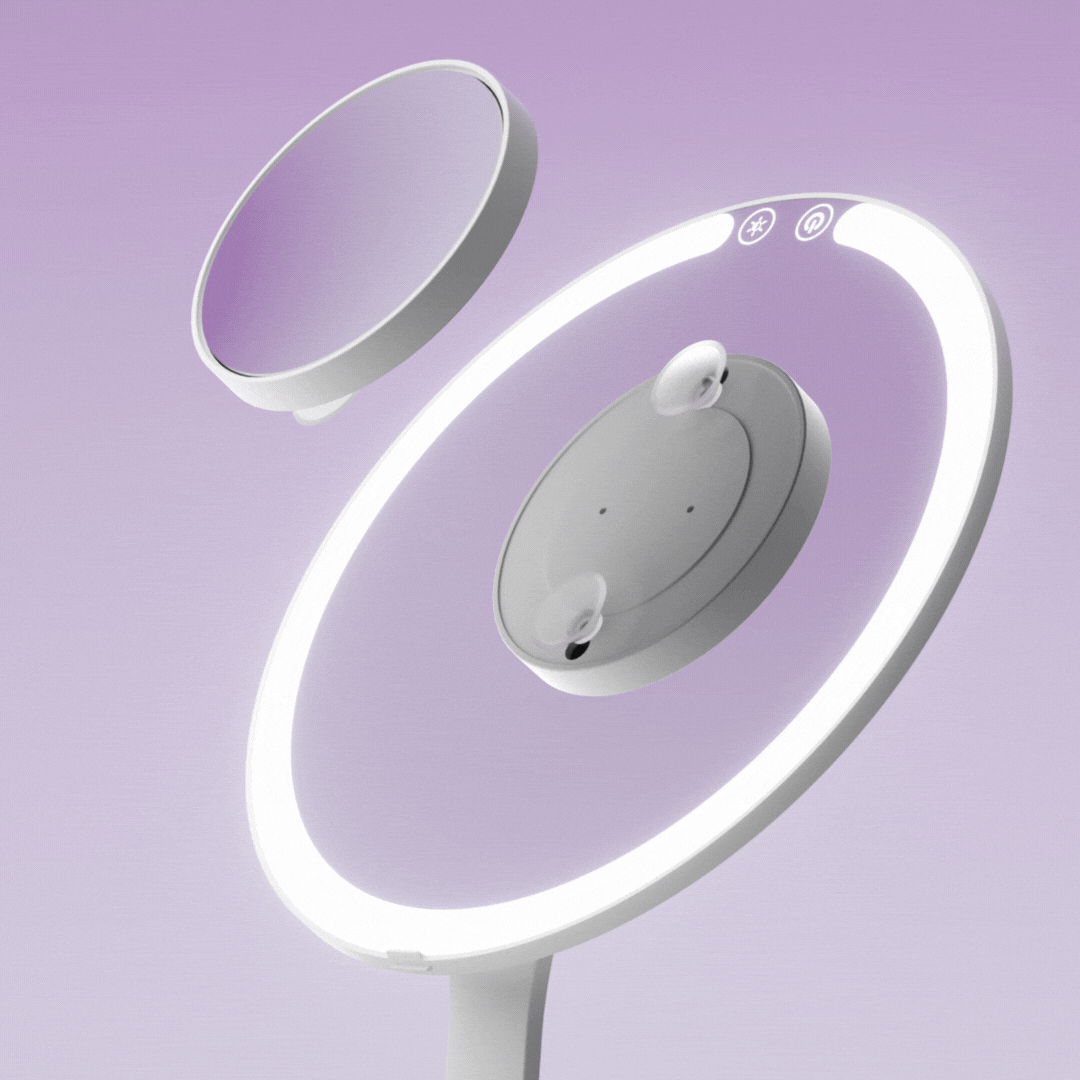 Tara 10x magnifying suction mirror showing how to attach to a lighted vanity mirror against a purple background.