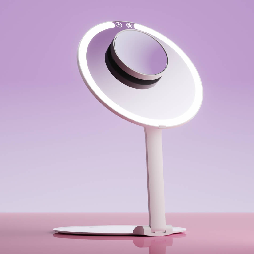 Tara 10x magnifying suction mirror attached to a white lighted vanity mirror for detailed makeup application.