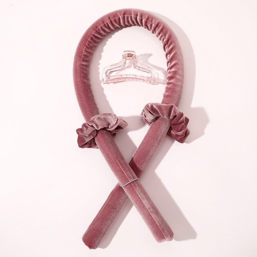 Pink velvet heatless hair curler set with two matching scrunchies and a clear claw clip for overnight heatless curls.